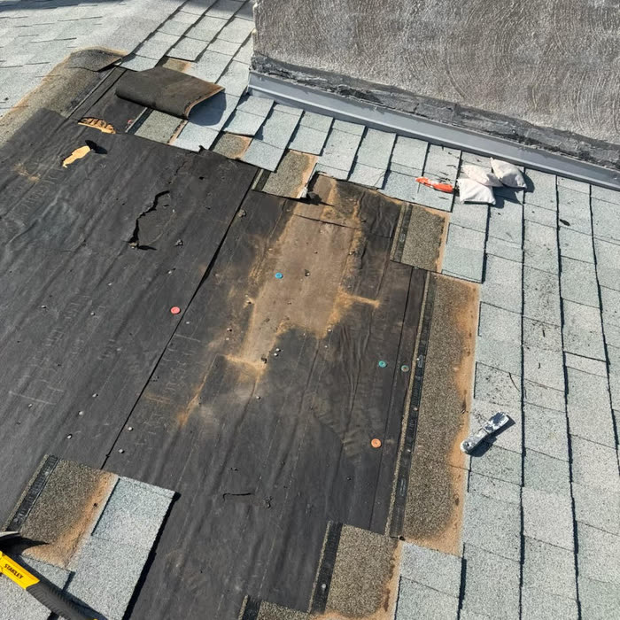 Before: damaged roof with torn underlayment and missing shingles